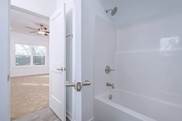 a bathroom with a bathtub and shower