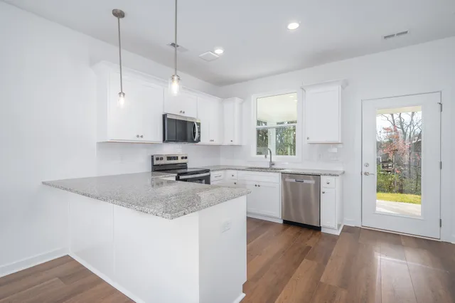 a kitchen with a sink window and cabinets