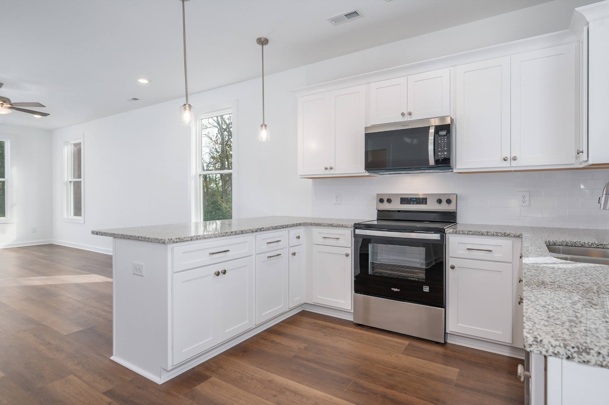 1170 Dickerson Road, Unit 22 Goodlettsville, TN 37072 - Photo 8 of 34 a kitchen with stainless steel appliances white cabinets a sink a stove a microwave and wooden floors