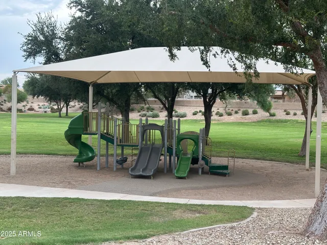 an outdoor space with lots of swings and slides