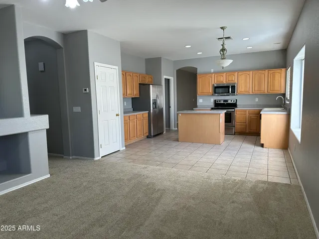 a large kitchen with a large counter top appliances and cabinets