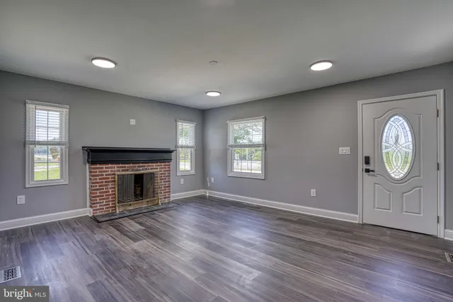 a kitchen with stainless steel appliances granite countertop a stove a sink dishwasher a refrigerator and a microwave oven