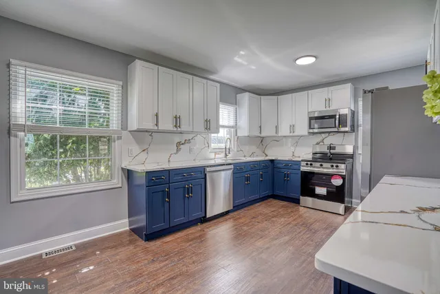 a bathroom with a sink toilet vanity and bathtub