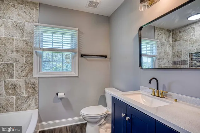 a view of an entryway with wooden floor and staircase