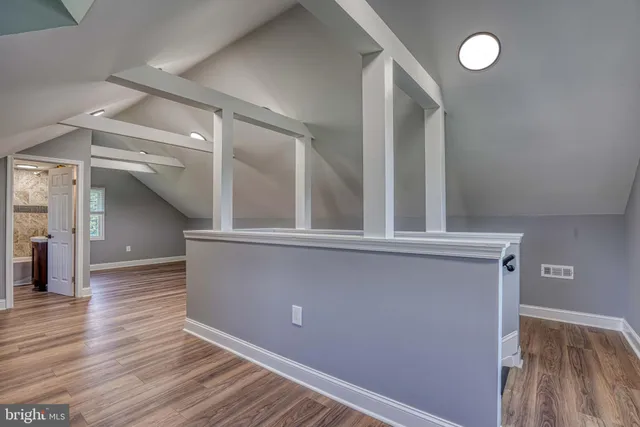 a view of a house with a big yard potted plants and large tree
