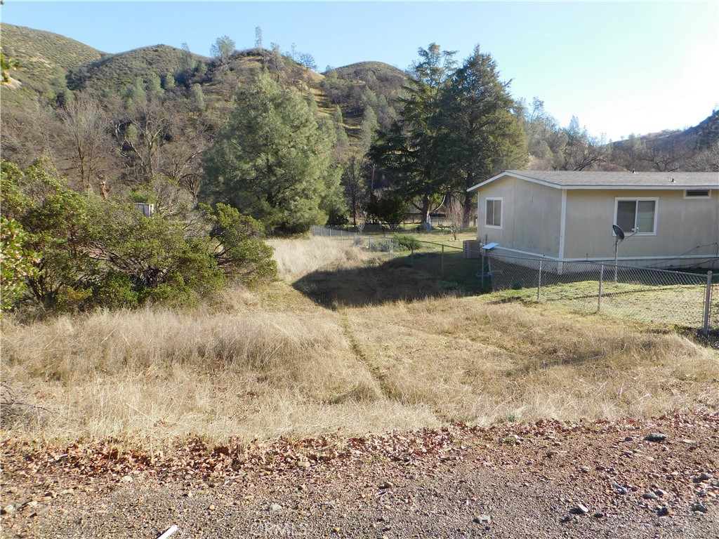 3660 Spring Valley Road Clearlake Oaks, CA 95423 - Photo 5 of 6 a view of a yard in front of a house