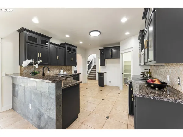 a kitchen with refrigerator and cabinets
