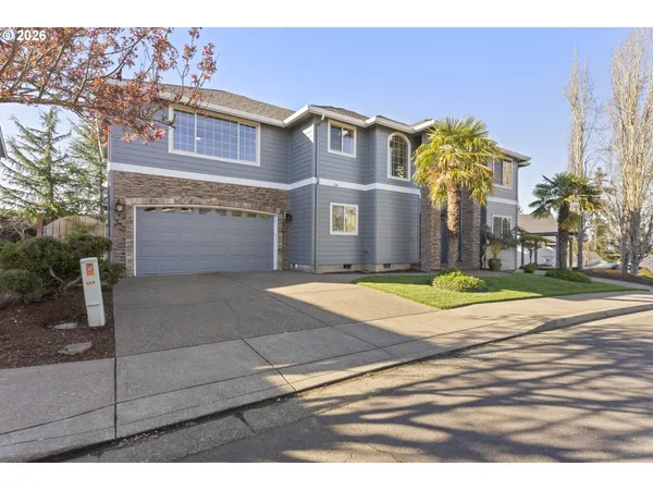 a front view of a house with a yard and garage