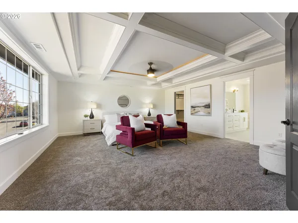 a spacious bedroom with a bed and a chandelier