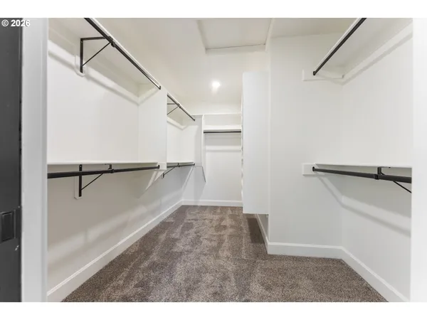 a spacious bathroom with a double vanity sink a mirror and a bathtub