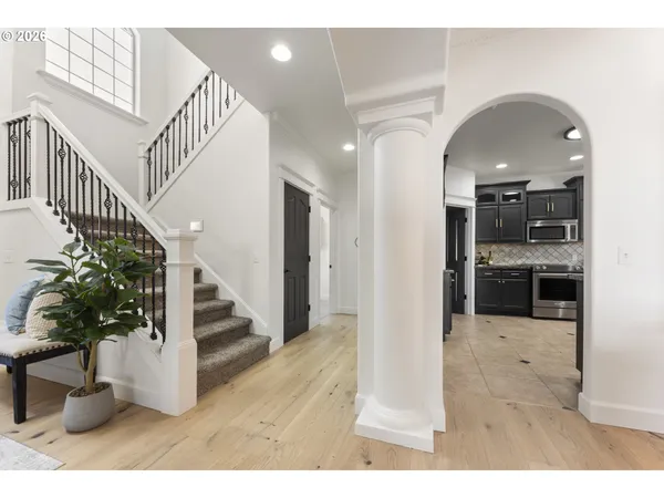 a view of entryway and hall with wooden floor