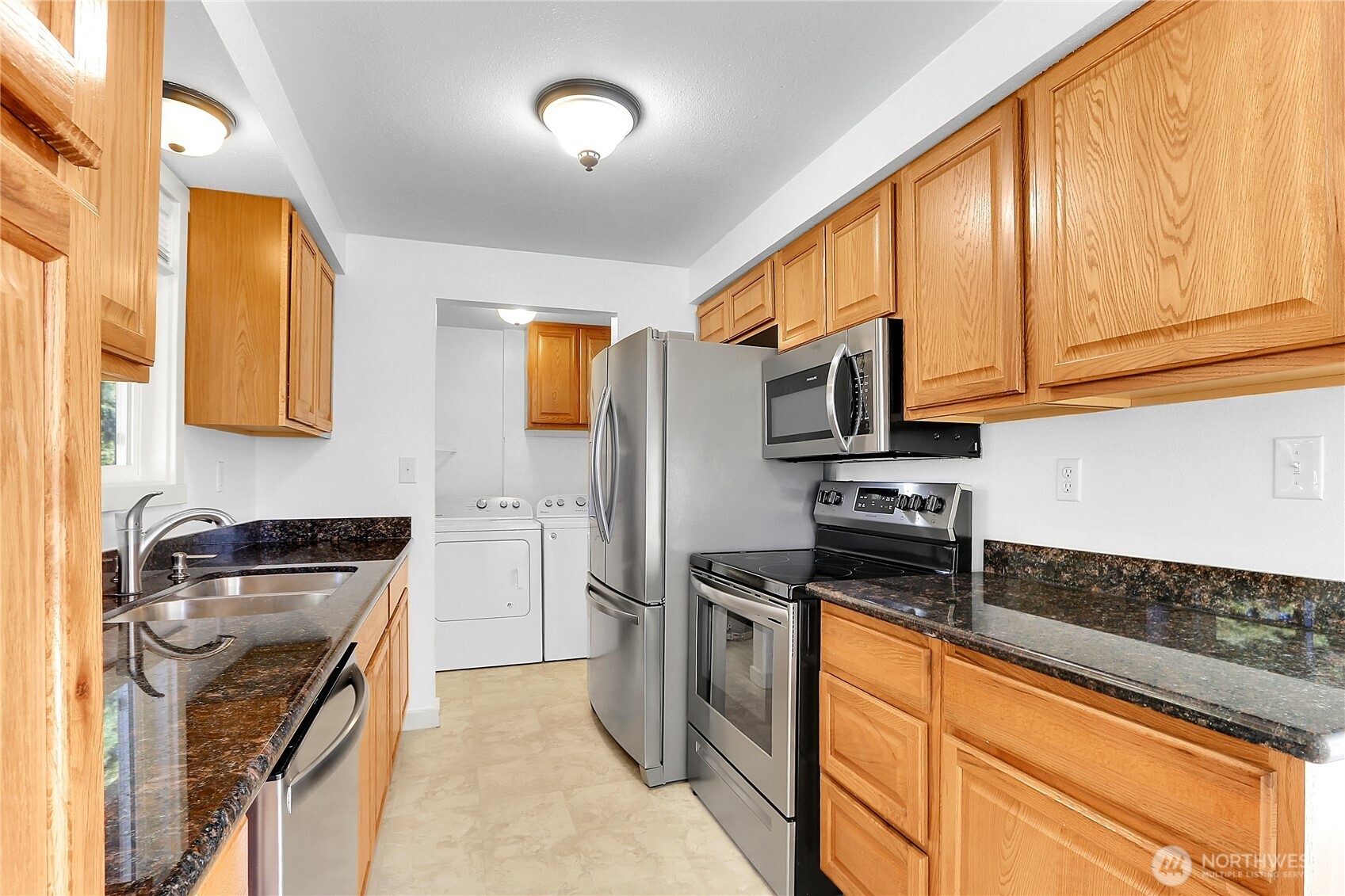 2115 Pinehurst Avenue Everett, WA 98203 - Photo 2 of 18 a kitchen with stainless steel appliances granite countertop a stove a sink dishwasher a refrigerator and cabinets with wooden floor