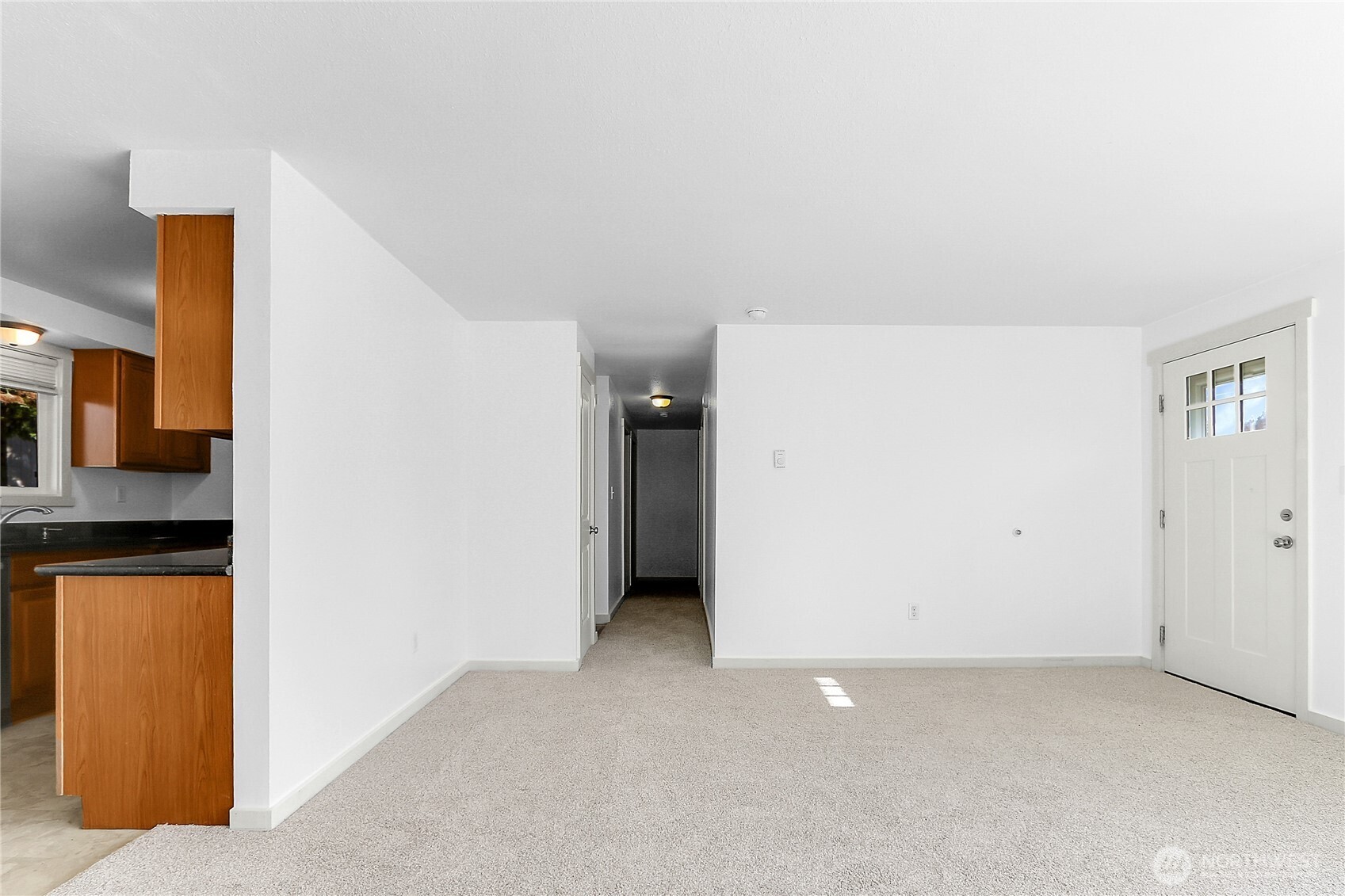 2115 Pinehurst Avenue Everett, WA 98203 - Photo 7 of 18 a view of a kitchen with fridge and wooden floor