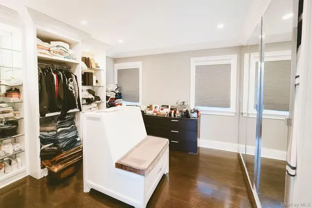 a living room with furniture a dining table and a refrigerator