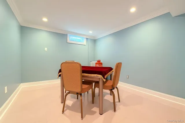 a dining room with furniture and a chandelier