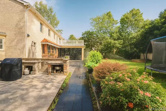 a view of a house with backyard porch and sitting area