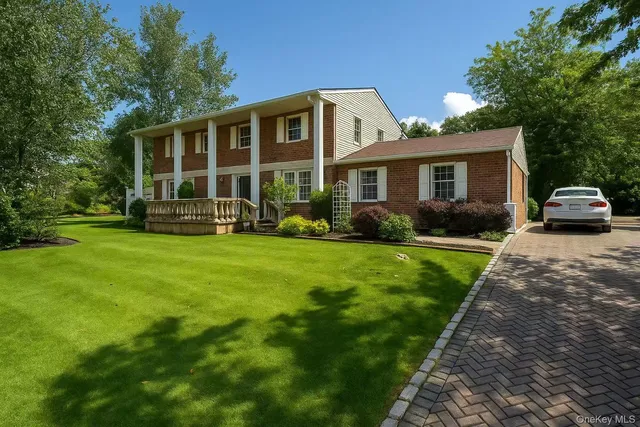 a front view of house with yard and green space