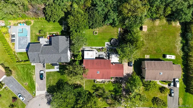 an aerial view of house with yard swimming pool and outdoor seating