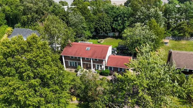 an aerial view of a house with yard and outdoor seating
