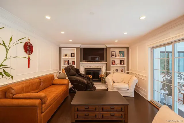 a living room with furniture fireplace and a window