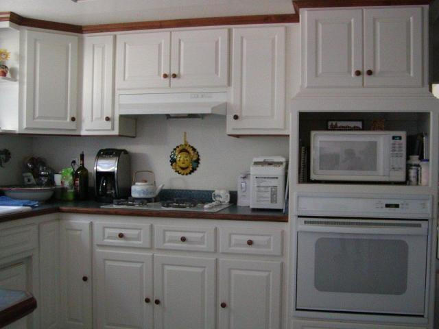 8277 Placer Road Redding, CA 96001 - Photo 6 of 9 a kitchen with white cabinets and appliances