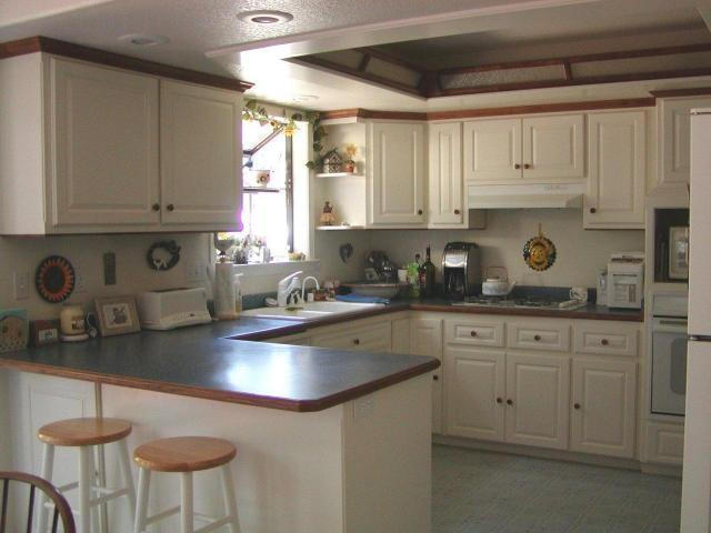 8277 Placer Road Redding, CA 96001 - Photo 7 of 9 a kitchen with a sink cabinets and window