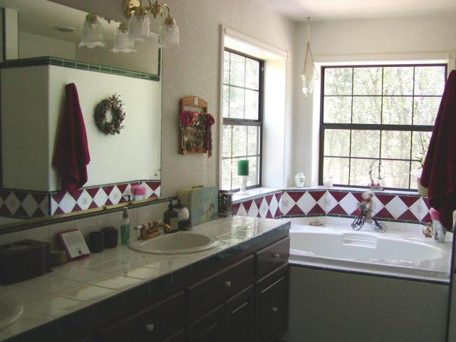 8277 Placer Road Redding, CA 96001 - Photo 9 of 9 a bathroom with a granite countertop sink a large mirror and a shower