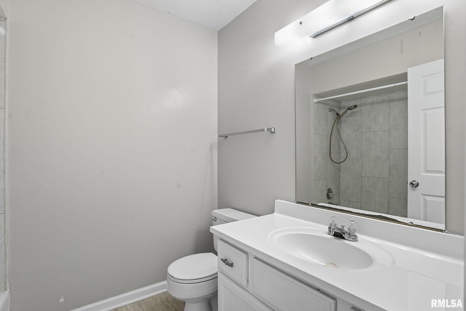 109 North 3rd Street Colona, IL 61241 - Photo 15 of 33 a bathroom with a sink toilet and vanity