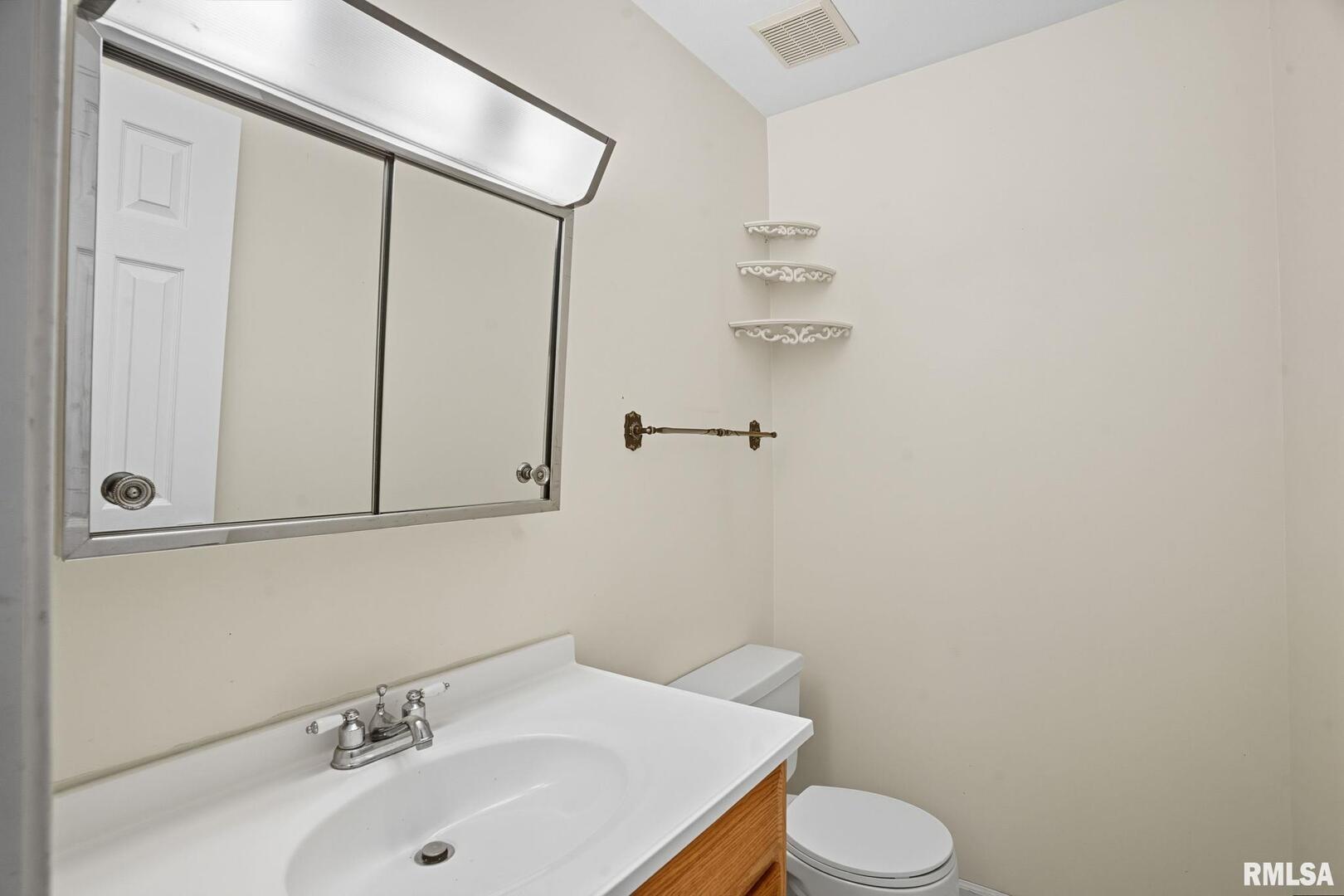 109 North 3rd Street Colona, IL 61241 - Photo 10 of 33 a bathroom with a sink a toilet and shower