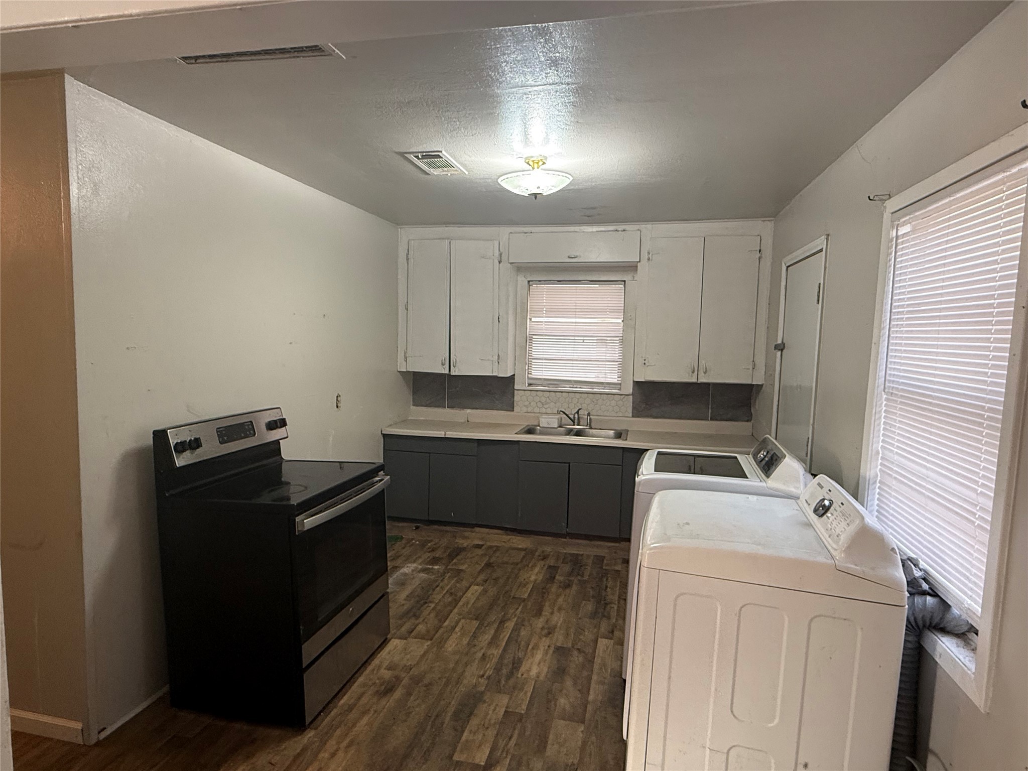 2210 Utica Street Beaumont, TX 77703 - Photo 14 of 17 a kitchen with a refrigerator and a stove top oven
