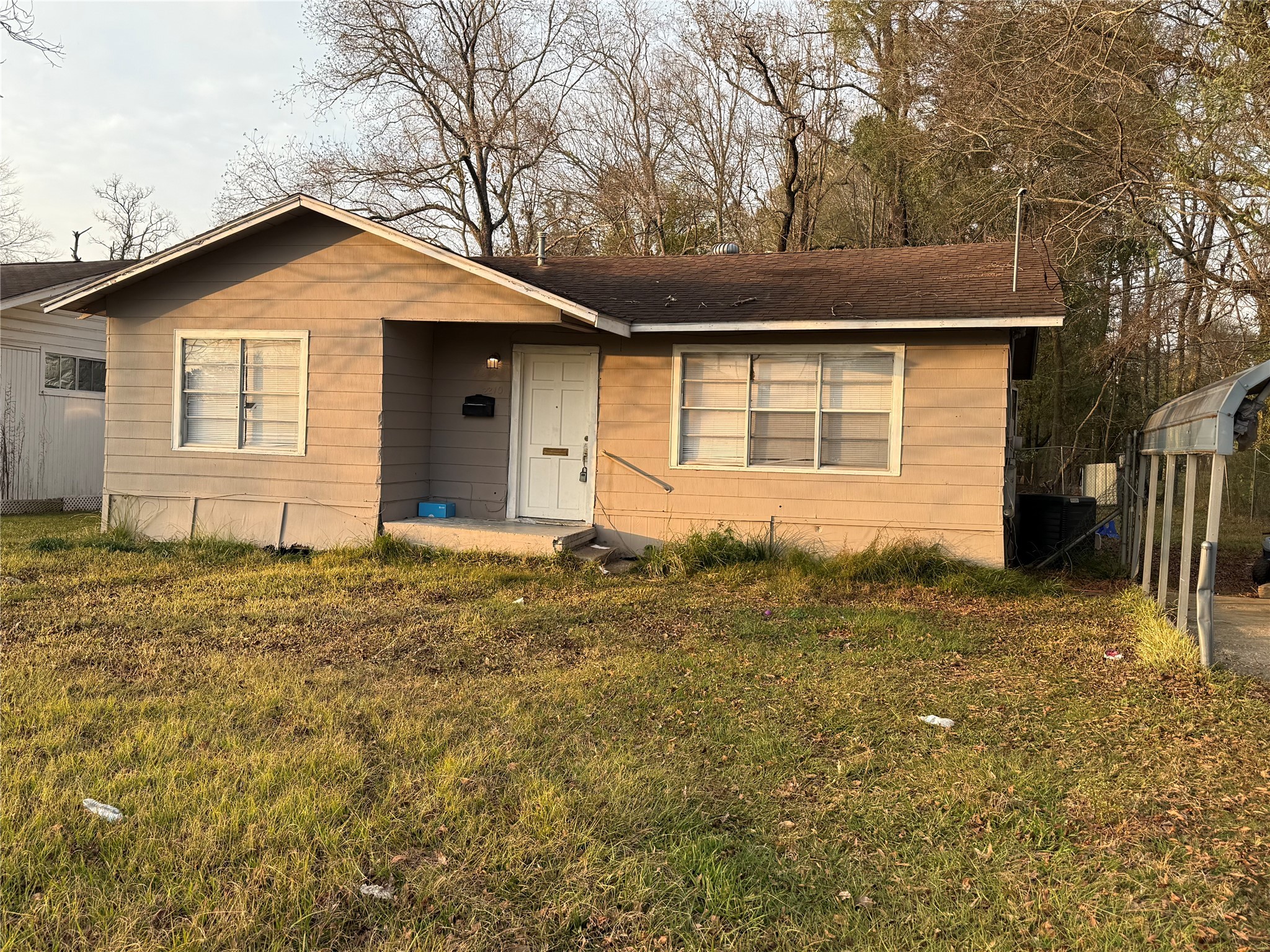 2210 Utica Street Beaumont, TX 77703 - Photo 2 of 17 a front view of a house with a yard and garage