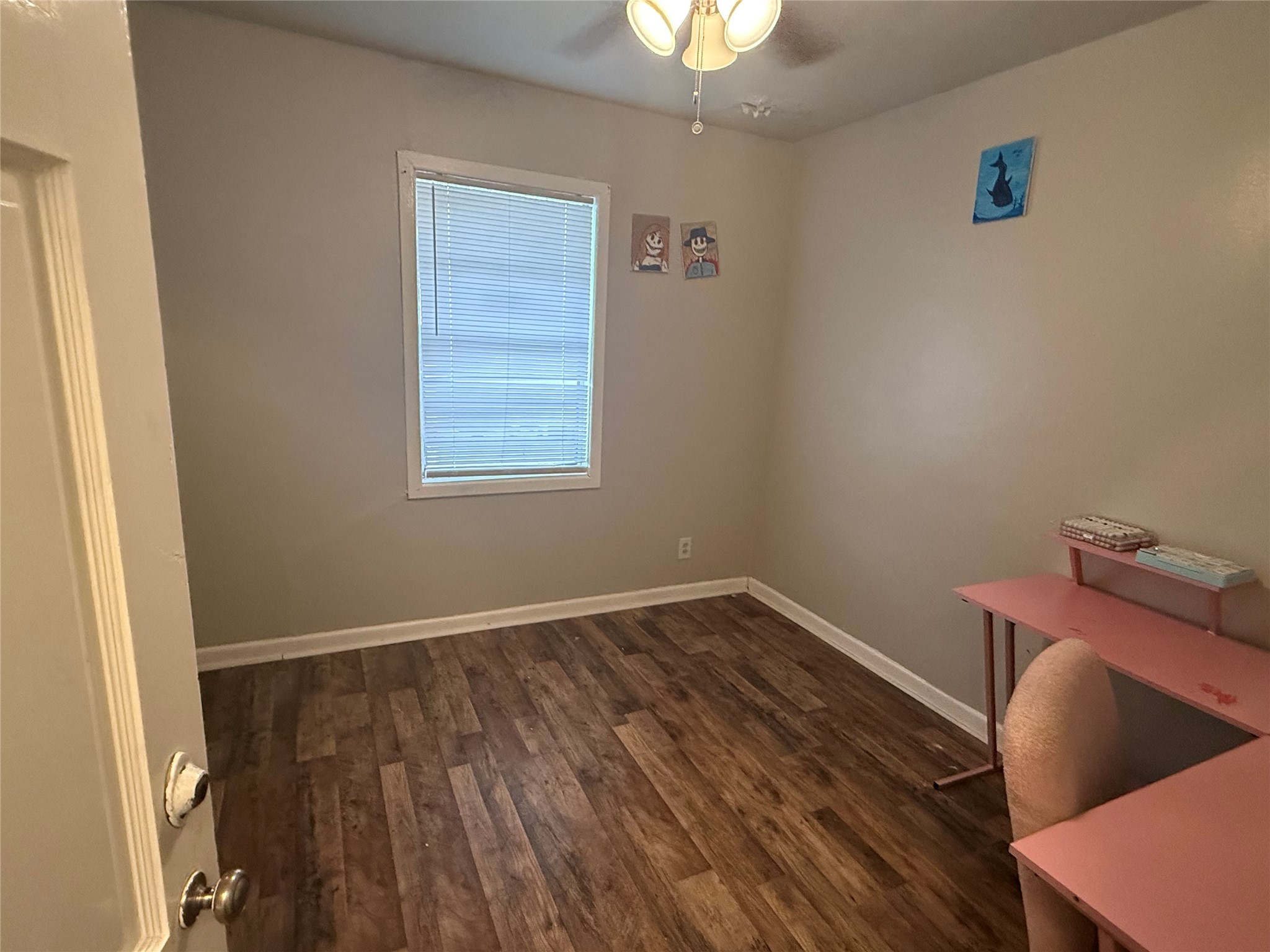 2210 Utica Street Beaumont, TX 77703 - Photo 7 of 17 a view of an empty room with wooden floor and a window