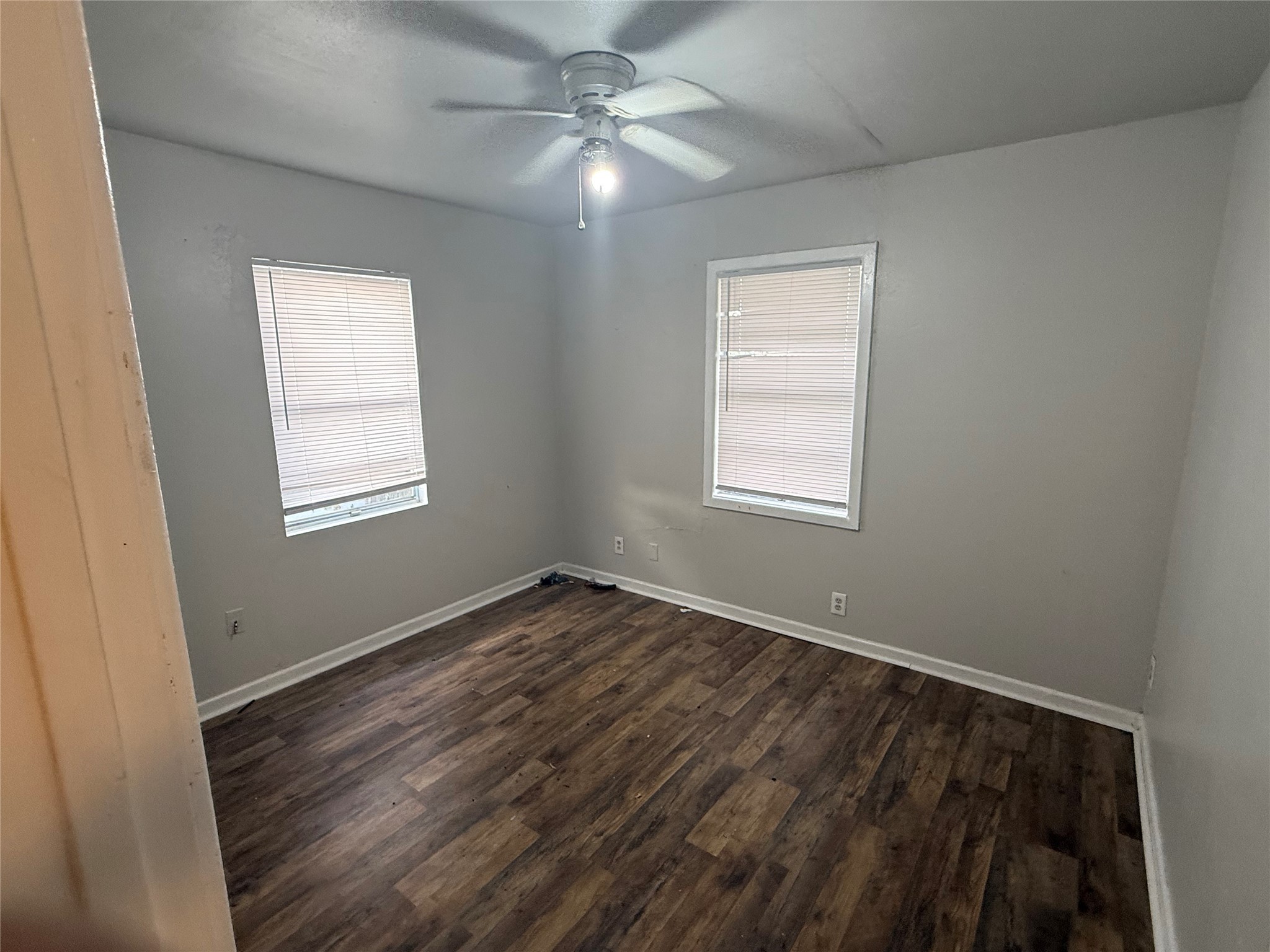 2210 Utica Street Beaumont, TX 77703 - Photo 8 of 17 a view of an empty room with wooden floor and a window