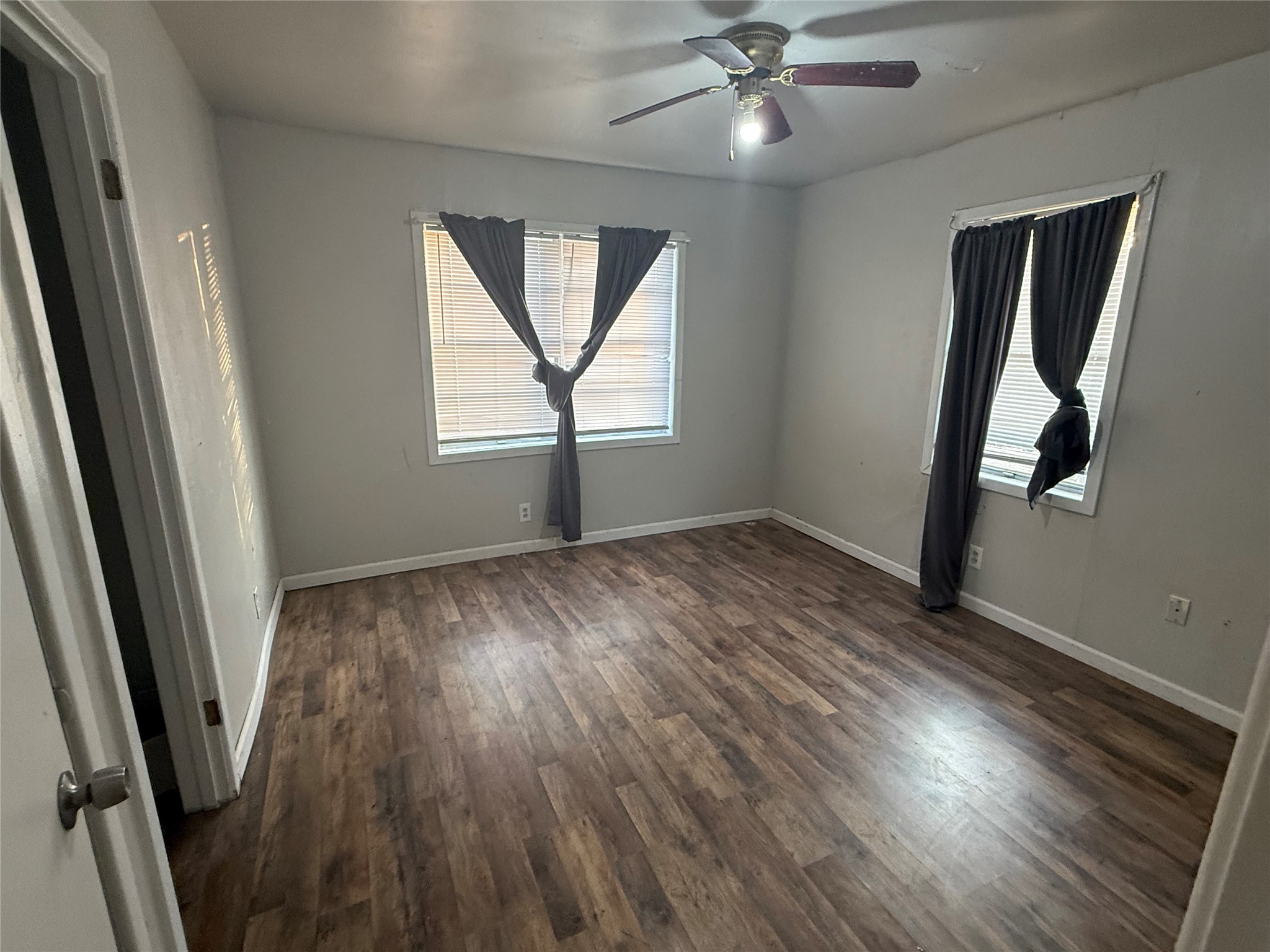 2210 Utica Street Beaumont, TX 77703 - Photo 9 of 17 wooden floor in an empty room with a window