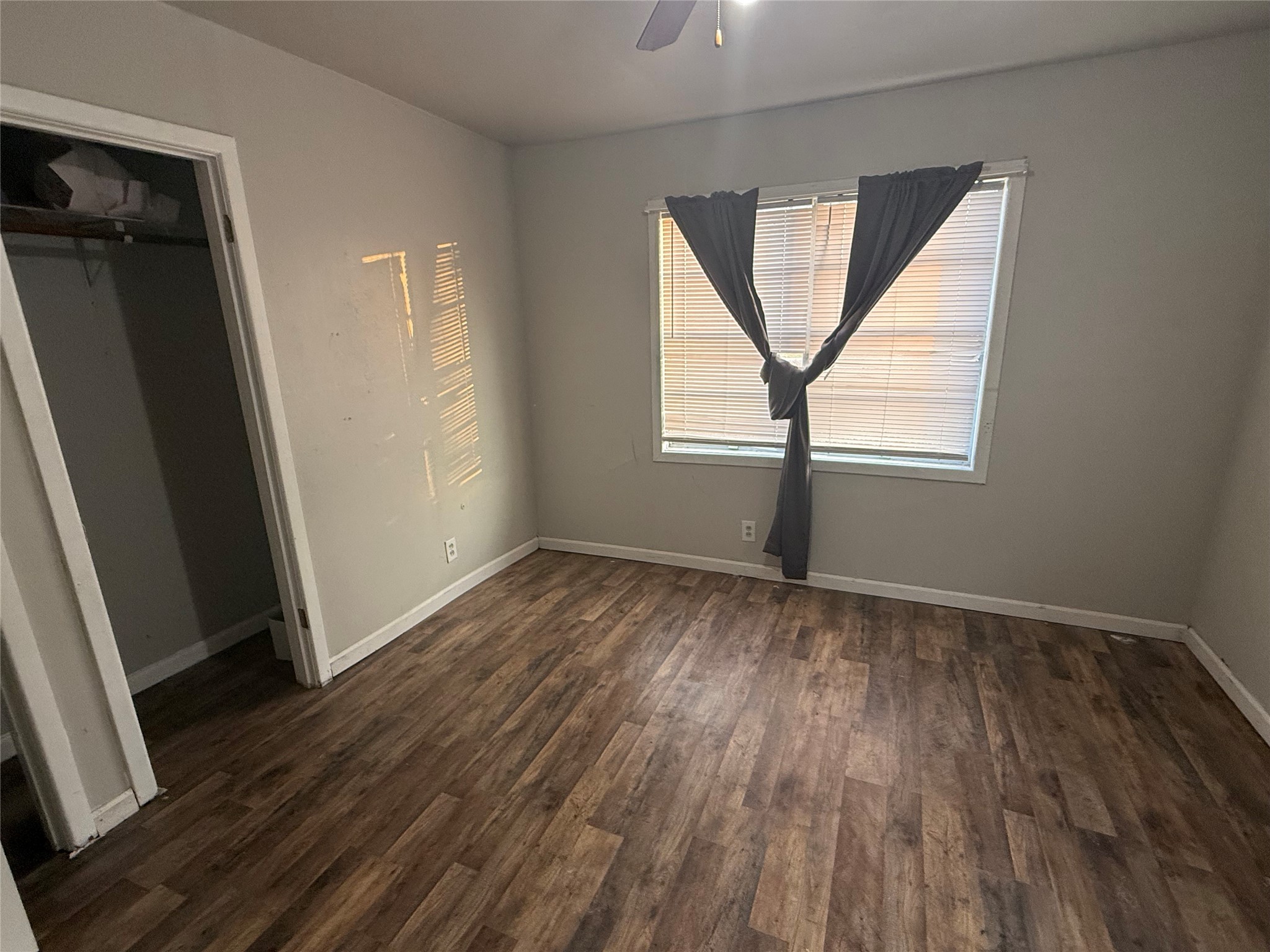 2210 Utica Street Beaumont, TX 77703 - Photo 10 of 17 an empty room with wooden floor and a window