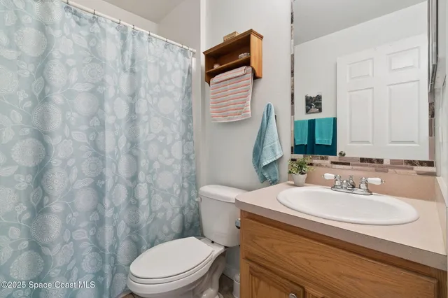 a bathroom with a sink toilet and mirror