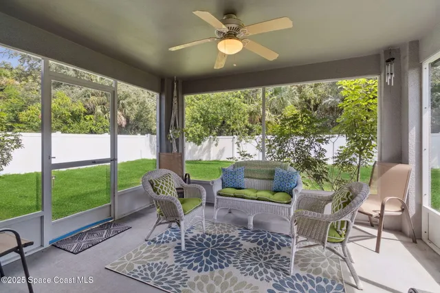 a living room with furniture and a garden