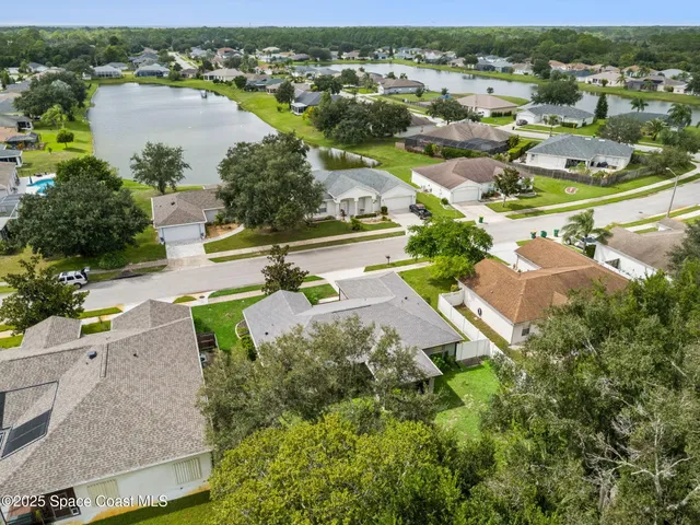 an aerial view of residential houses with outdoor space and river