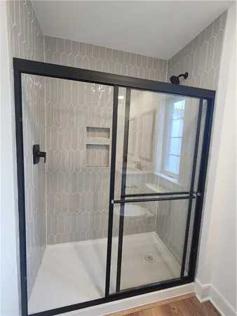 a bathroom with a glass shower door