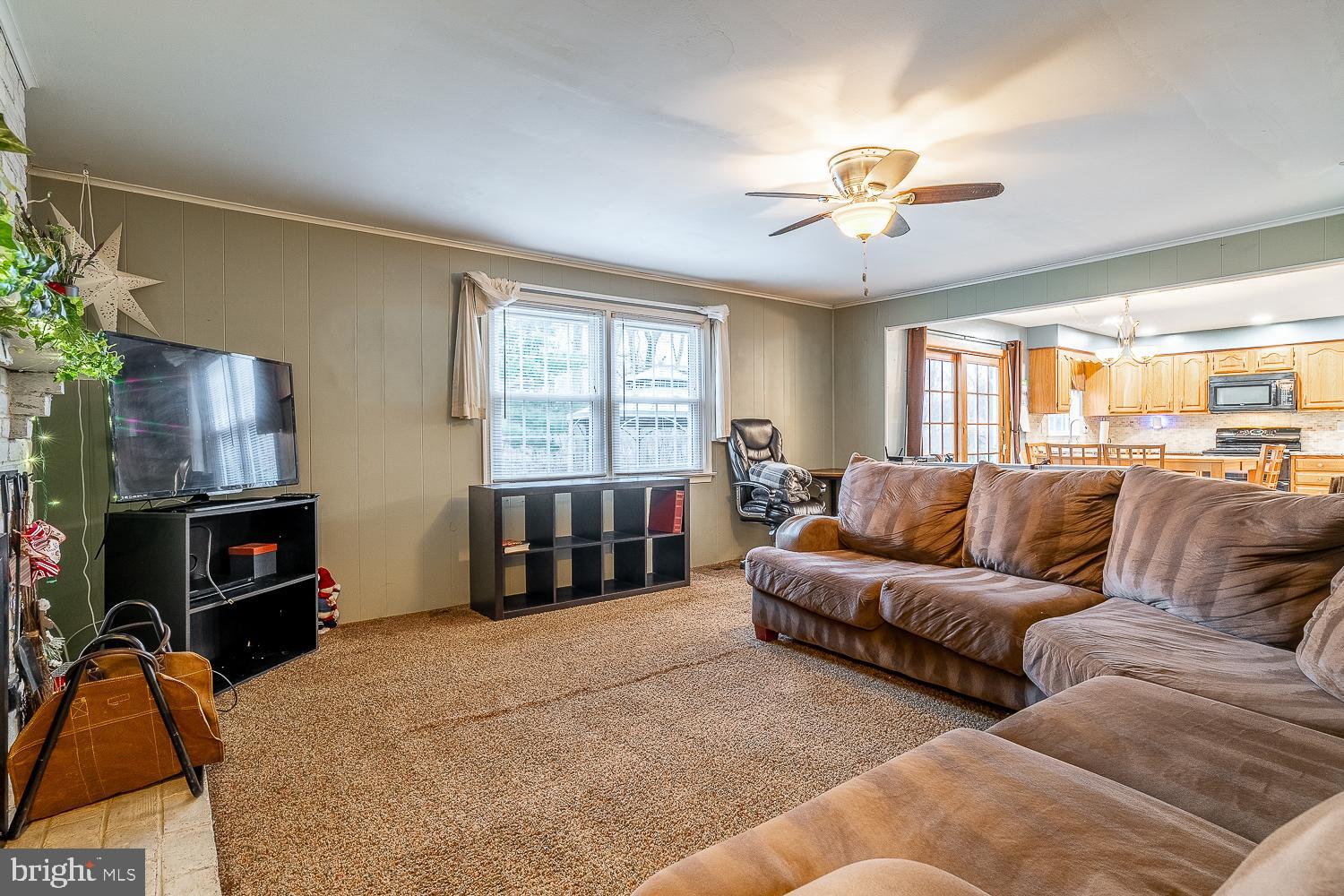 421 Hampton Lane Somerdale, NJ 08083 - Photo 13 of 35 a living room with furniture a flat screen tv and a fireplace