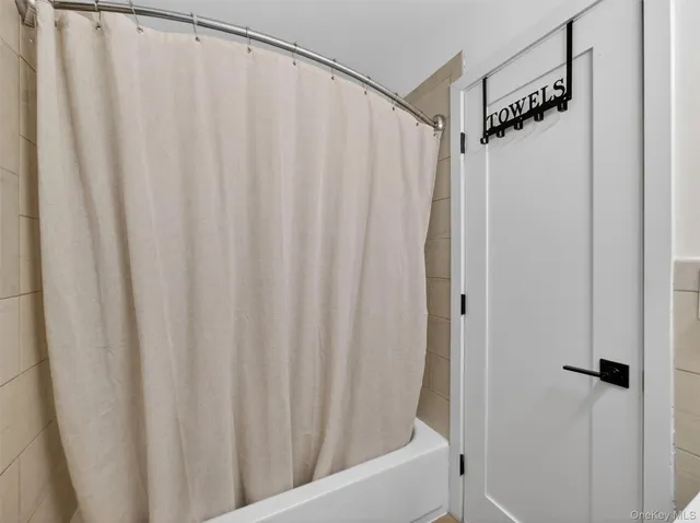 a bathroom with a shower and a tub