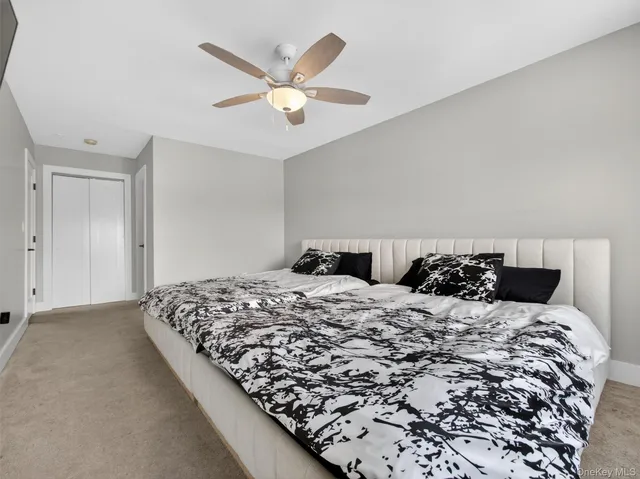 a bedroom with a large bed and a chandelier