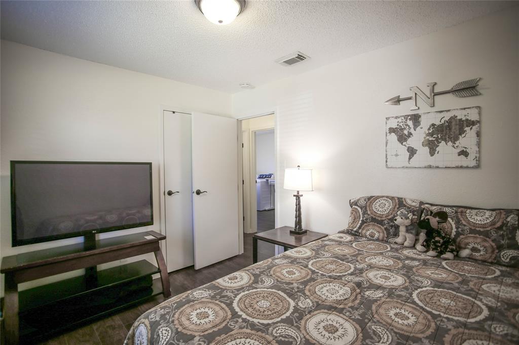 1720 Crystal Way Plano, TX 75074 - Photo 21 of 32 a bedroom with a bed and a flat screen tv
