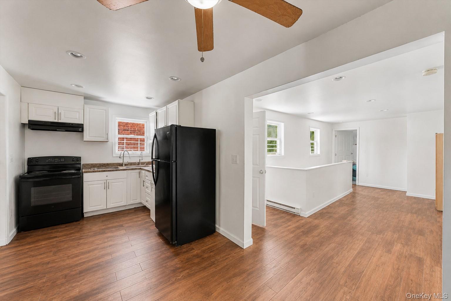 931 Diven Street Peekskill, NY 10566 - Photo 5 of 29 Kitchen and hallway to second bedroom and stairs to lower level