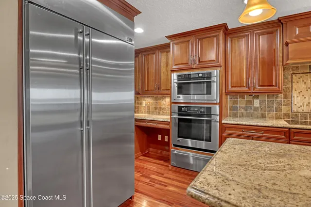 a kitchen with stainless steel appliances granite countertop wooden cabinets a sink and dishwasher