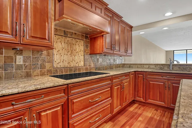 a kitchen with granite countertop a stove and a microwave