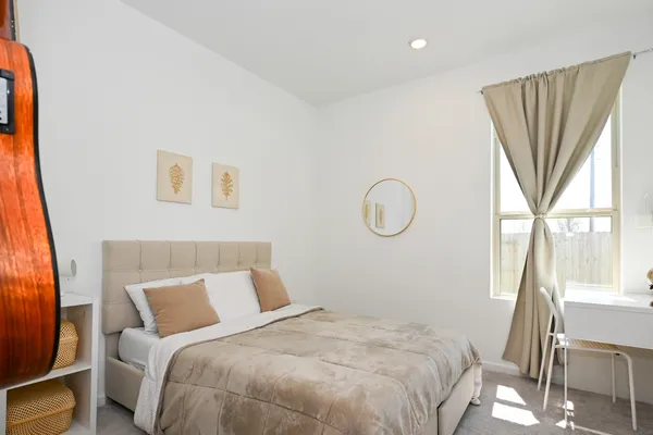 a bedroom with a bed and a window