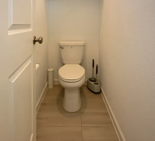a bathroom with a toilet and a granite floor