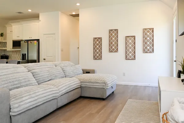 a spacious bedroom with a bed a couch and a window