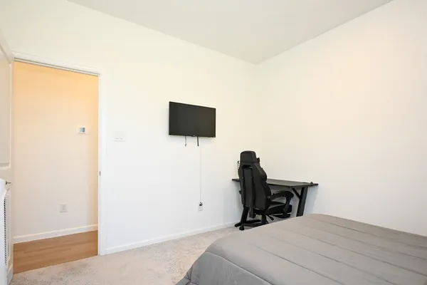 a room with a bed and a flat screen tv